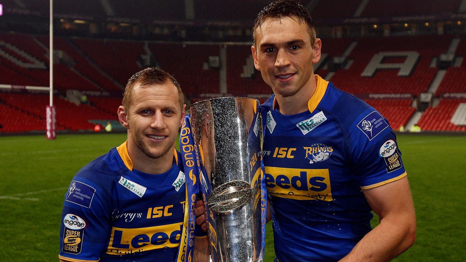 two sports men standing next to each other holding a trophy. Burrow and Sinfield after Leeds Rhinos'