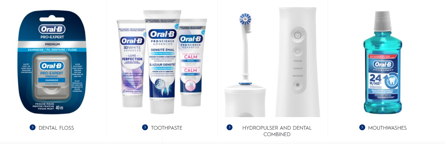 a group of Oral B toothbrushes and toothpaste